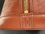 an image of a brown purse with a zipper on it