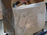 a cardboard box sitting on a pallet in the middle of a room