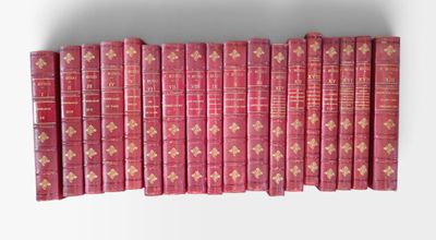les livres sont alignés en rangées sur une surface blanche