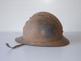 an old helmet sitting on top of a white table