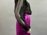 a mannequin mannequin wearing a purple skirt and black blouse