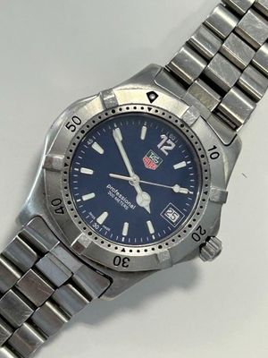 a close up of a watch on a white surface