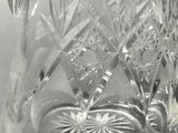 a glass vase with a swan on it on a table