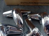 four chromed motorcycle mirrors sitting on top of a table next to a cardboard box
