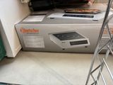 a box that is sitting on the floor next to a stove