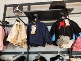 a lot of clothes hanging on a rack in a store