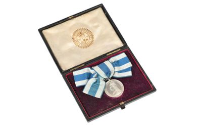 an image of a medal in a box with a ribbon around it