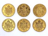 six different types of gold coins on a white surface