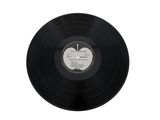 a black vinyl record with a white label on it