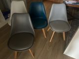 three chairs sitting next to each other on a wooden floor
