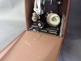 a brown suitcase with a camera inside of it