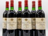 six bottles of red wine are lined up in a row