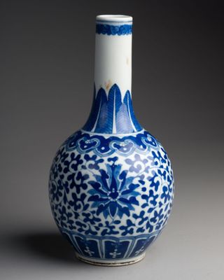 a blue and white vase that is sitting on a table