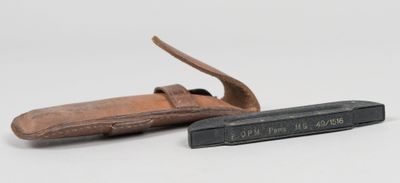 a small knife and a leather sheath on a white surface