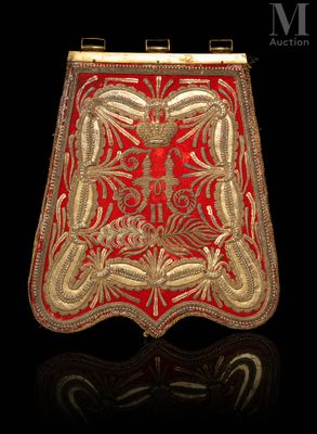 a red and gold purse on a black surface
