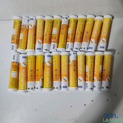 a lot of tubes of toothpaste sitting on a table