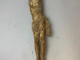 statue représentant un homme sur une croix, posée sur une surface blanche
