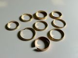 several gold rings are arranged in a circle on a white surface