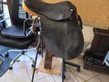 a saddle that is sitting on a stand in a room