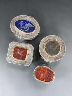 four silver and glass items including a ring, a ring, and a box