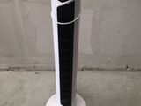 a black and white tower air conditioner sitting on the floor