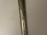 a close up of a knife on a table with a wooden handle