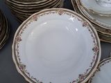 many plates and bowls stacked on a table