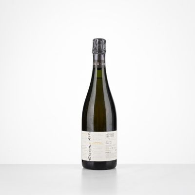 a bottle of white wine sitting on top of a table