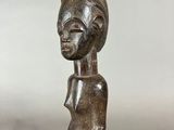 a bronze statue of a woman holding a baby in her arms
