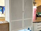 an image of a bedroom with a bed and a dresser