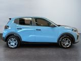 a blue car is parked in a room with a gray floor
