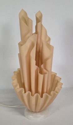 a vase that has a bunch of folded paper in it