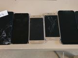 several cell phones are displayed on a table with a price tag