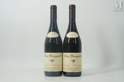 two bottles of red wine sitting on top of a white table