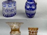 four different types of glass vases and a pitcher