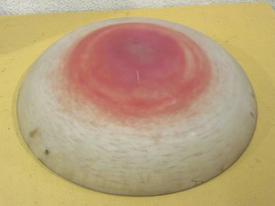 a red spot on the top of a white object