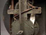 a metal clock with a clock face and gears on it