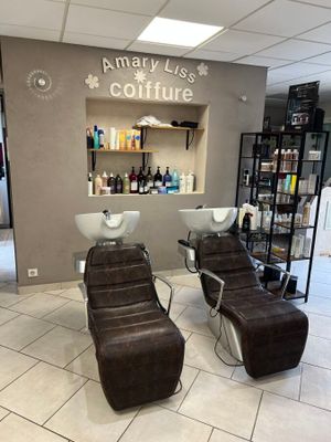 a picture of a salon with two chairs and a counter
