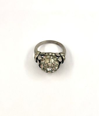 a close up of a diamond ring on a white surface