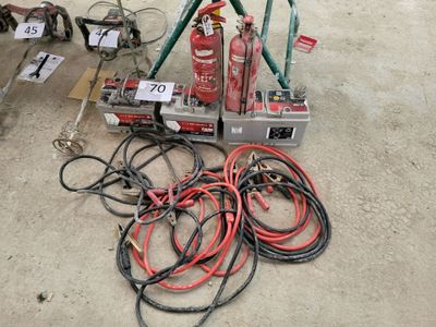 a fire extinguisor sitting on the ground next to some wires