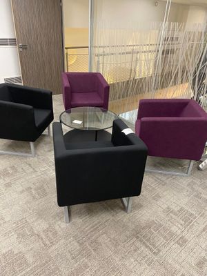 three chairs and a table in the middle of a room