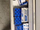 many boxes of blue and white boxes in a cabinet