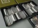 a box of silverware sitting on a table next to a box of silverware