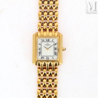 a close up of a gold wrist watch with roman numerals on it