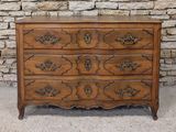 an antique chest of drawers with a marble top