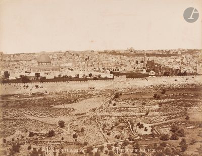 an old photo of a view of a city in the middle of the desert