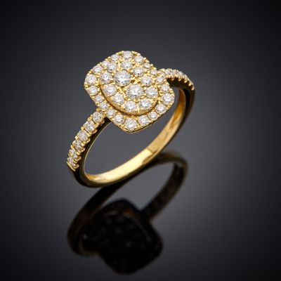 a yellow gold ring with diamonds on a black background