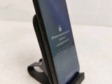 a phone that is sitting on a stand on the table