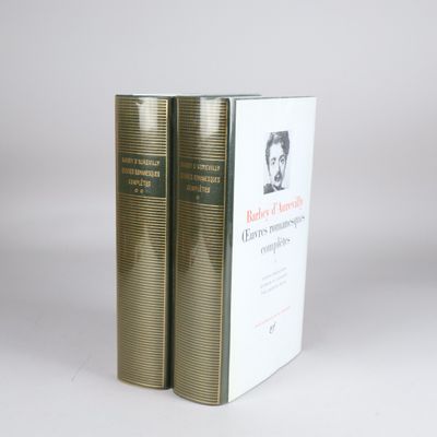 two books sitting on top of each other on a white surface