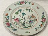 a plate with a bird on it on a table